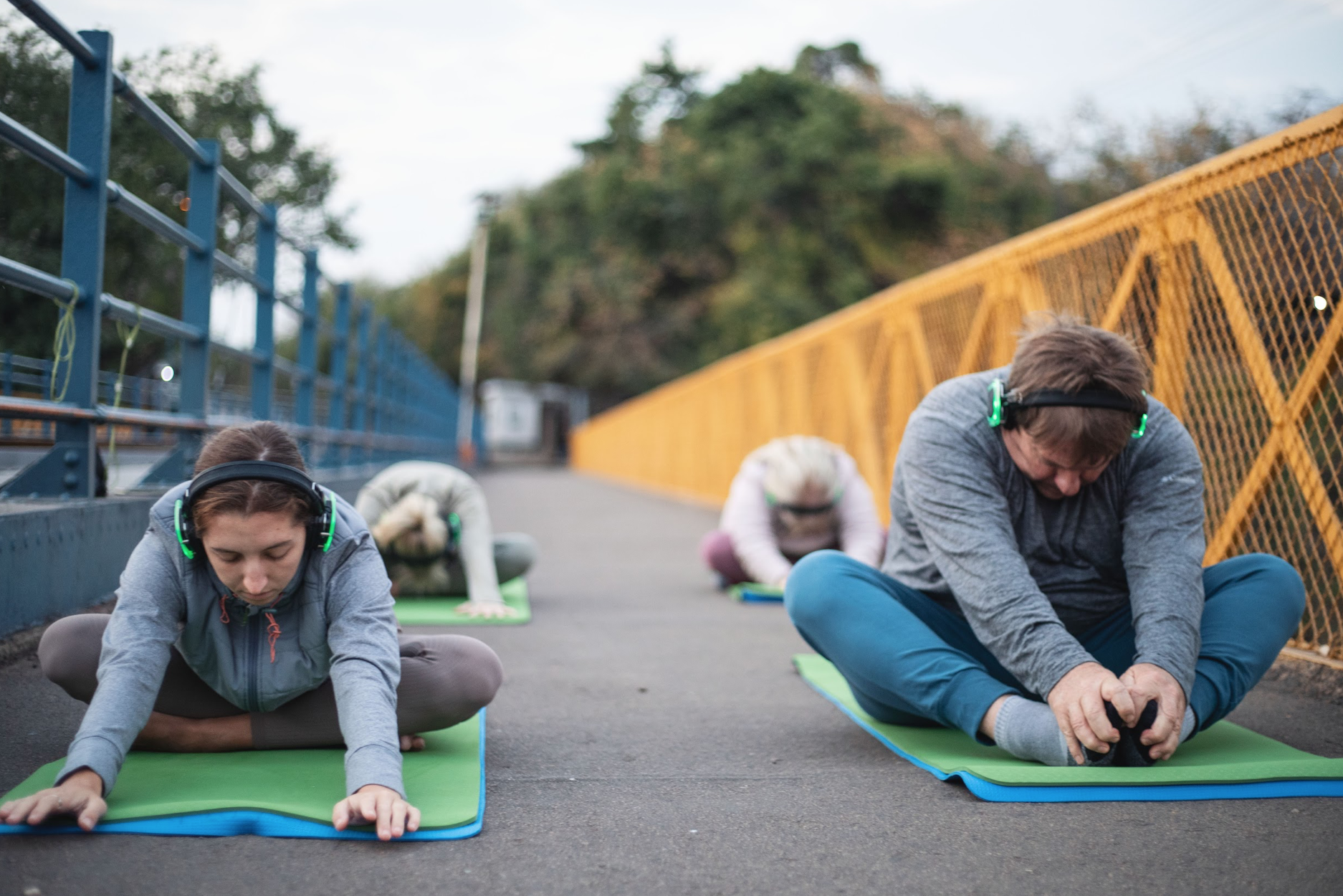 Group in silent-headphone yoga class on the Victoria Falls Bridge