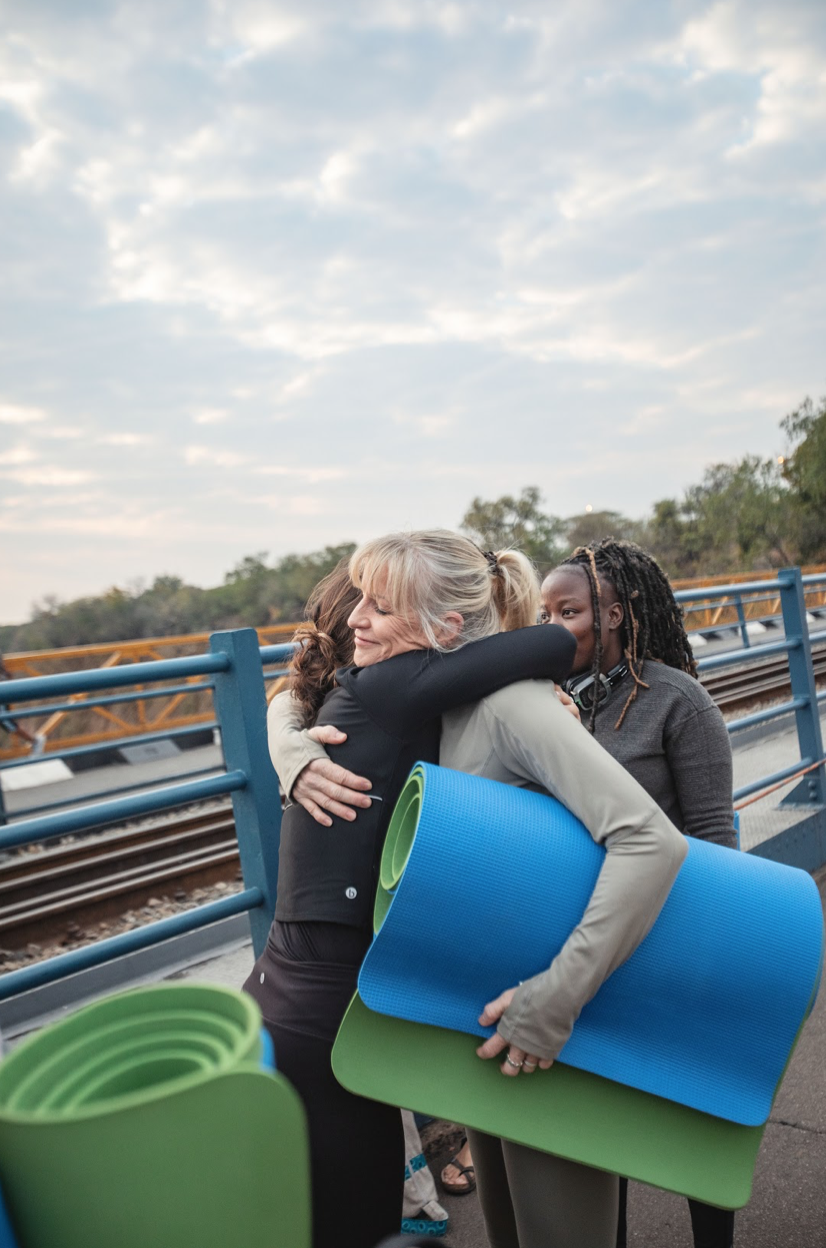 Group practising at sunrise on the Victoria Falls Bridge