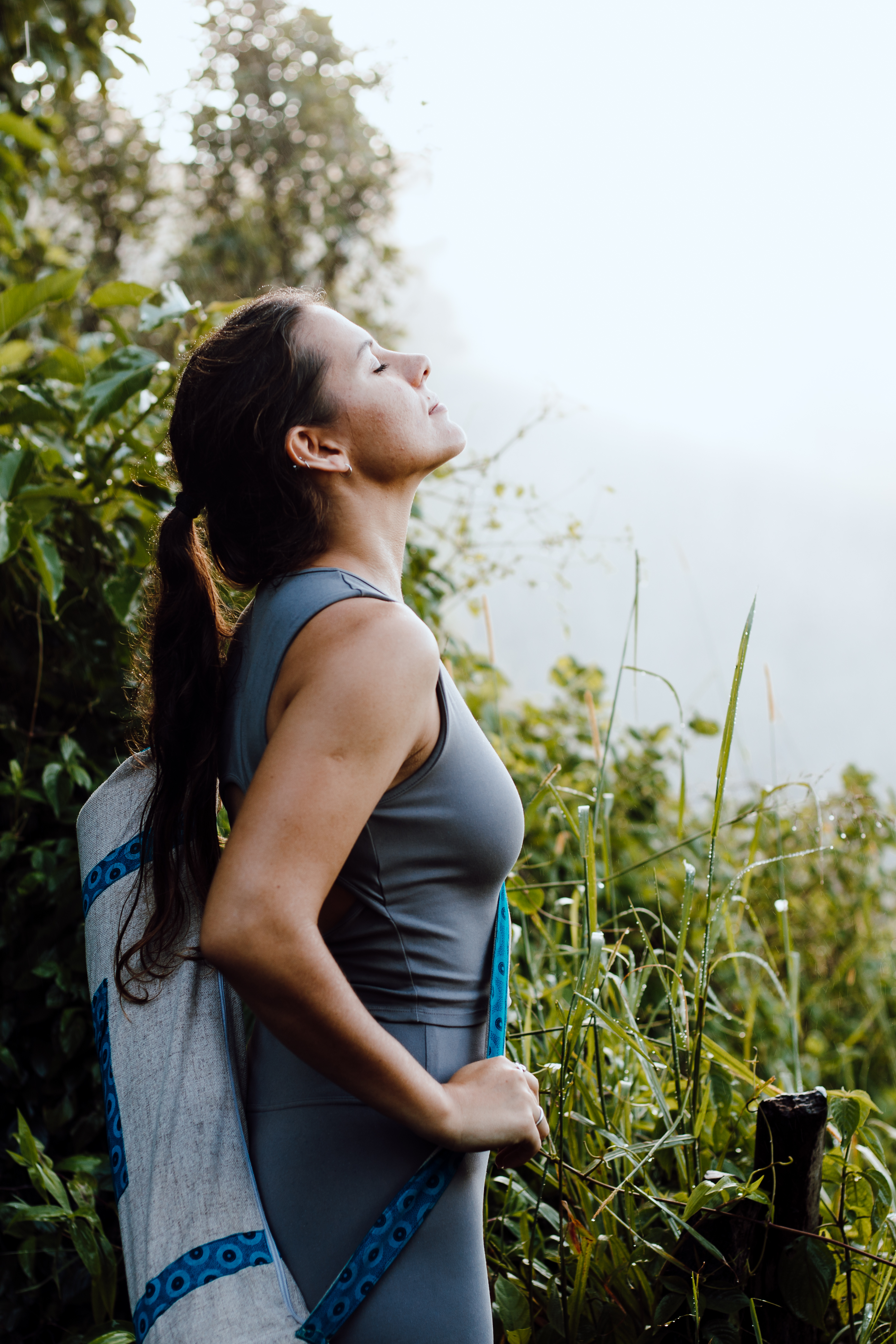 Guest pausing to breathe with a yoga mat near Victoria Falls