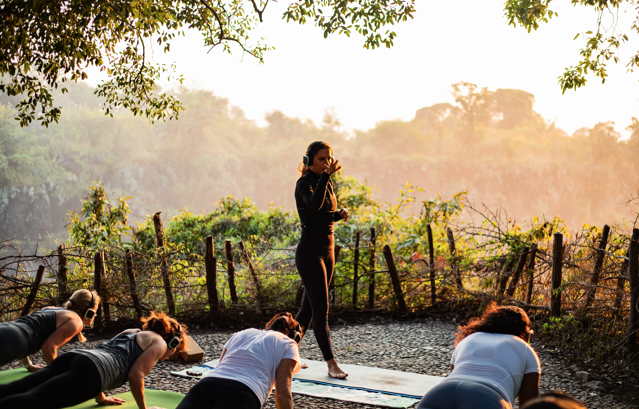 Group standing in practice wearing headphones above Victoria Falls
