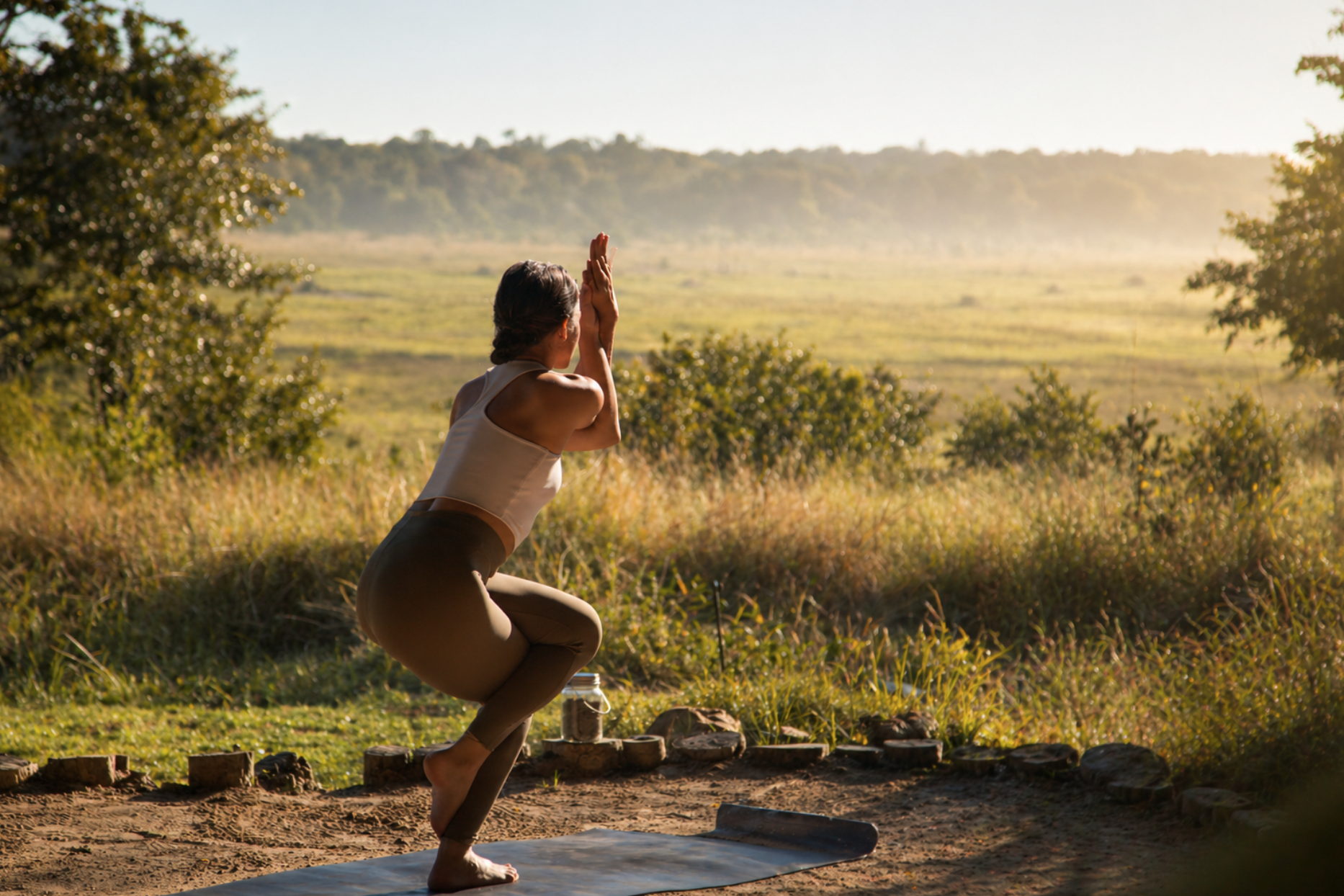 Guest in prayer hands pose facing the Victoria Falls Bridge