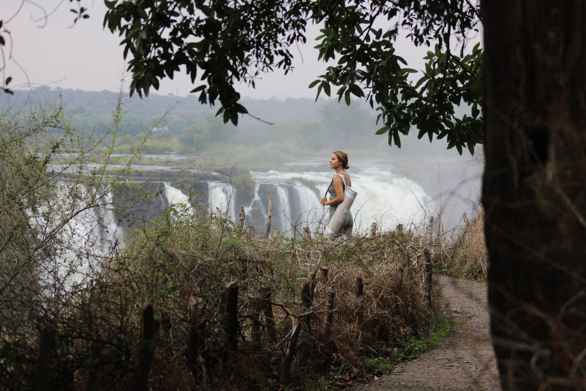A guide walking a trail overlooking Victoria Falls